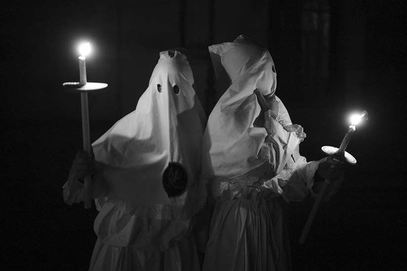 Altar boys light the path with candles